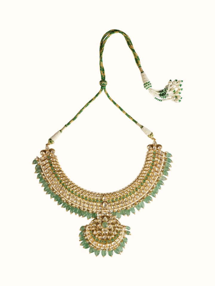 front view of silver smithing gold plated jadau necklace with intricate stone work