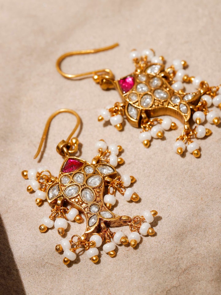 Overhead shot showing the earrings’ length and delicate drop shape