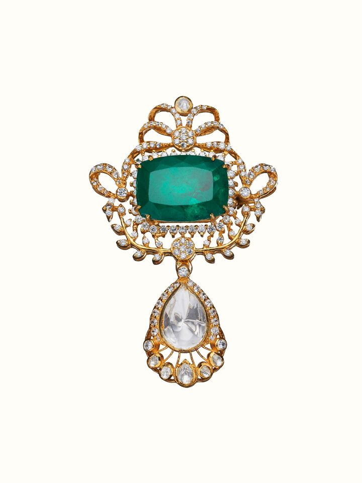 front view of silver smithing yellow gold brooch pin with intricate design