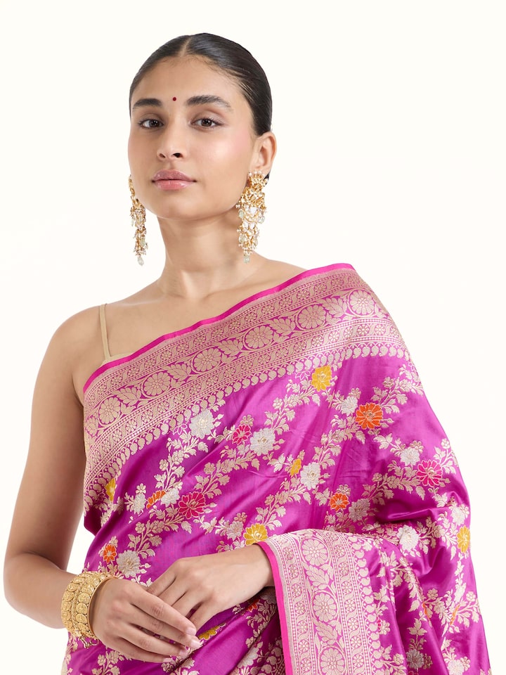 Angled view of magenta Banarasi silk kadwa jaal saree highlighting kadwa weave and lustrous sheen
