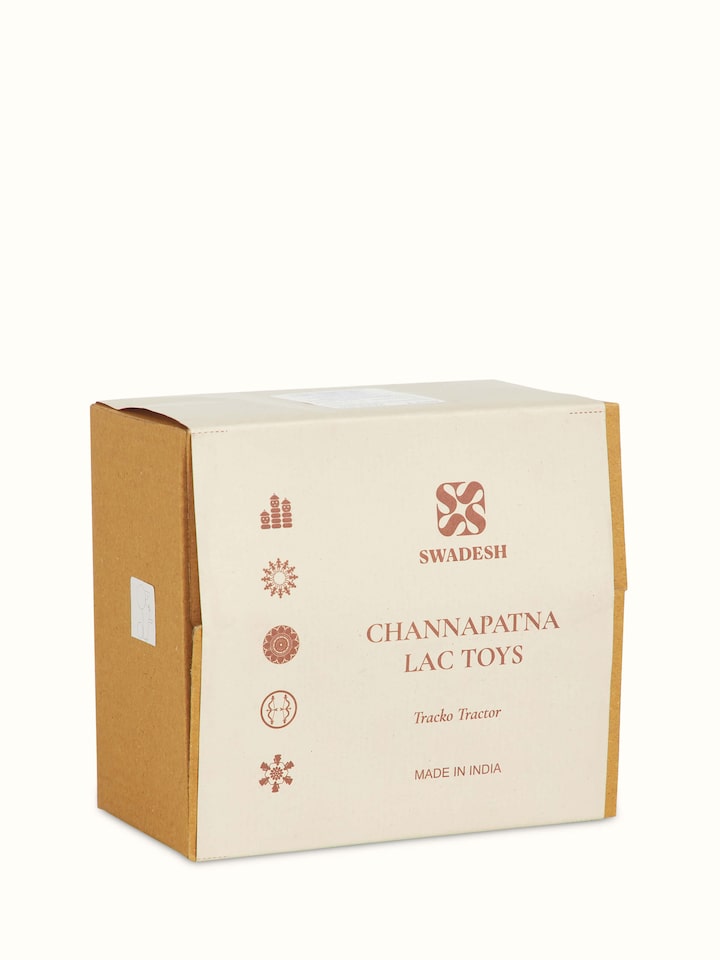 Detailed close-up of white Channapatna ivory wood tractor toy highlighting craftsmanship