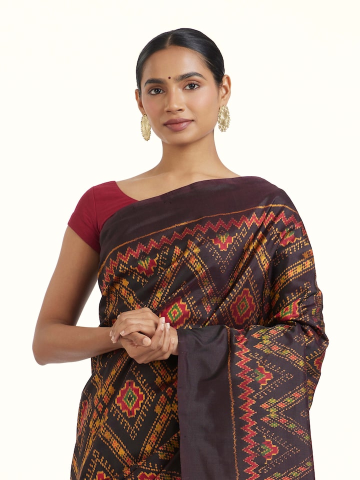 Angled view of Brown Pochampally Combodia Ikat Silk Saree revealing the depth of its color and intricate pattern