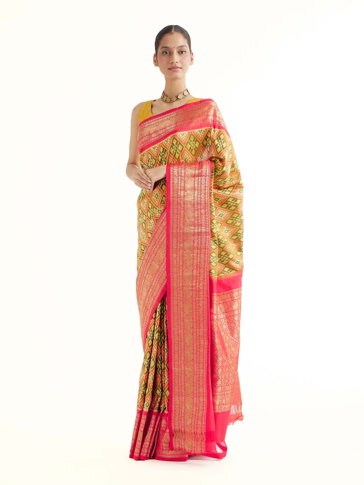Side view of green silk ikat saree showcasing fluid drape