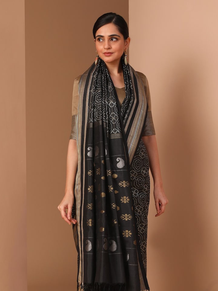 Close-up detail of black silk double Ikat saree highlighting dyed precision and fabric sheen
