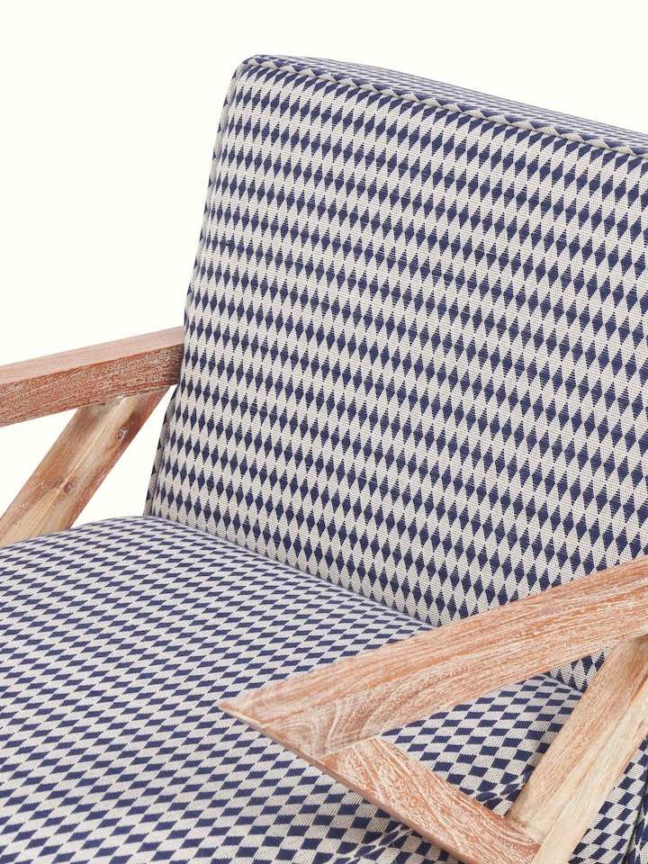 Detailed back view of Swadesh Upholstered Acacia Wood Armchair displaying the rich wood finish and plush back support