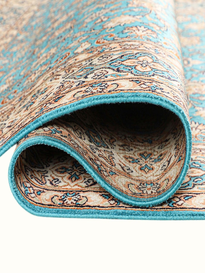 Detailed view of the Traditional Persian Turquoise Medallion Kashmir Silk Hand-Knotted Carpet craftsmanship