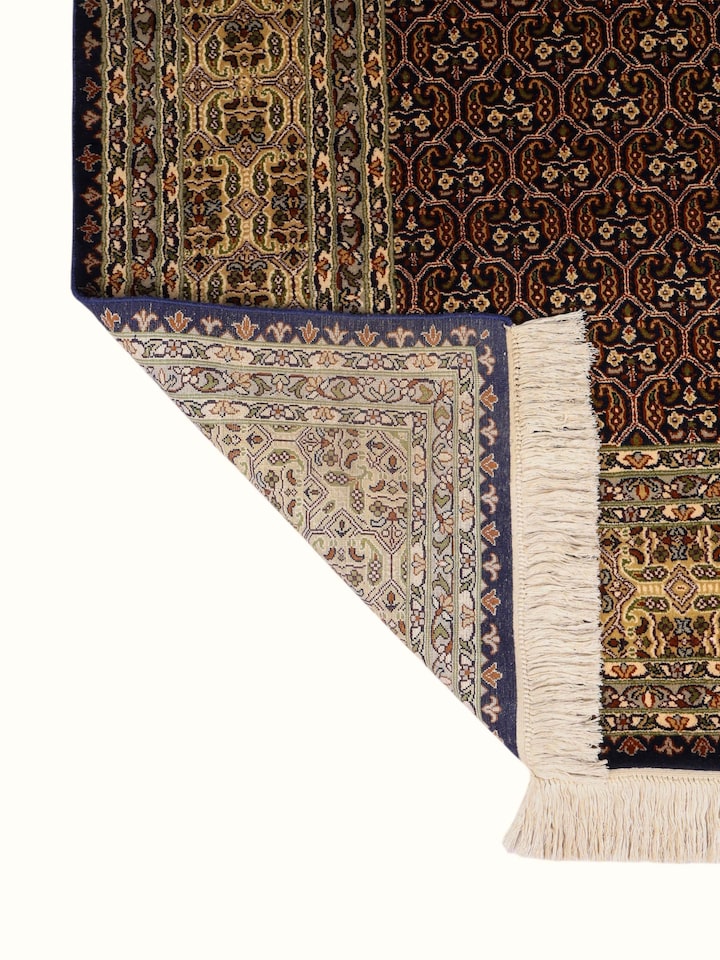 Side-angle view of the Traditional Persian Navy Ivory Senneh Kashmir Silk Hand-Knotted Carpet
