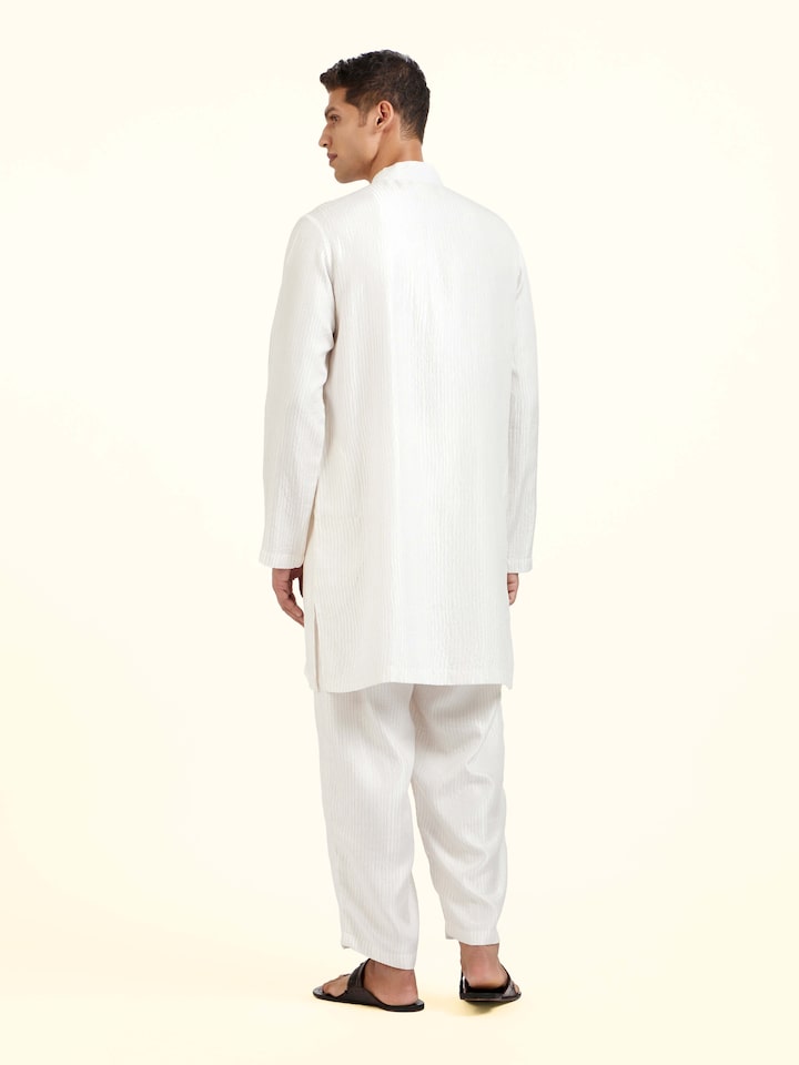 Back view of white straight quilted tulip pants with clean finishing and shape
