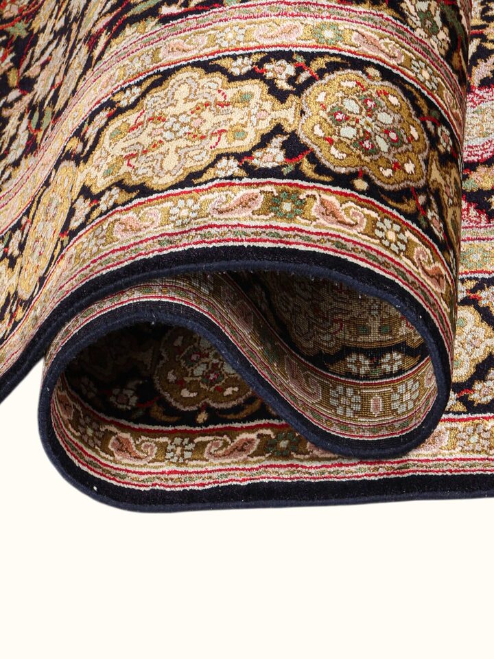 Detailed view of the Traditional Persian Black Ochre Ardebil Kashmir Silk Hand-Knotted Carpet craftsmanship