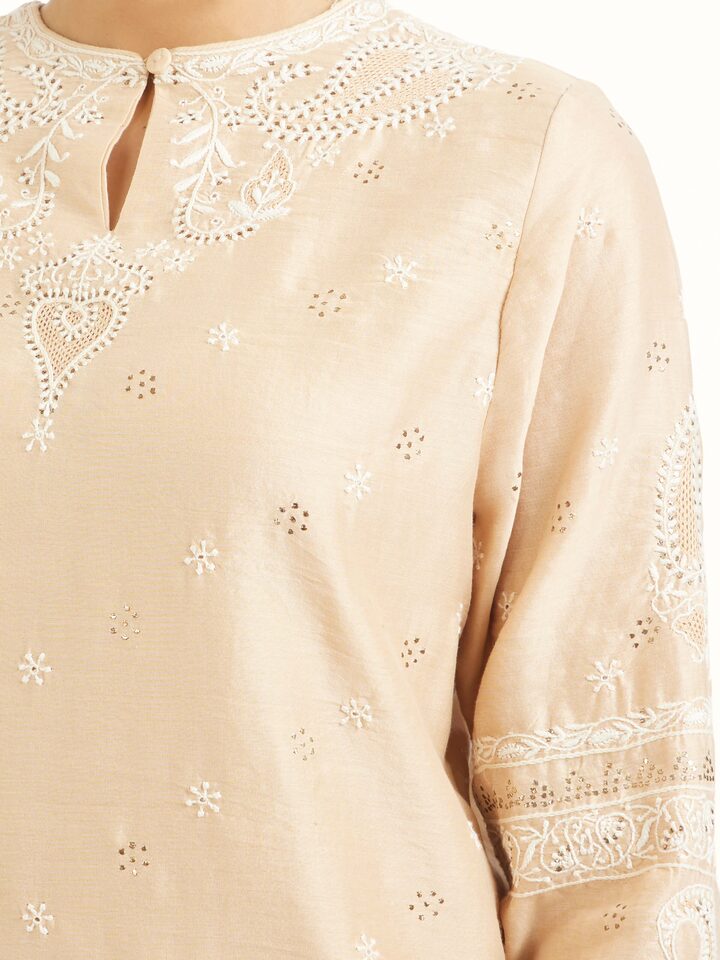Detail view of beige silk chikankari kurta showing chikankari work