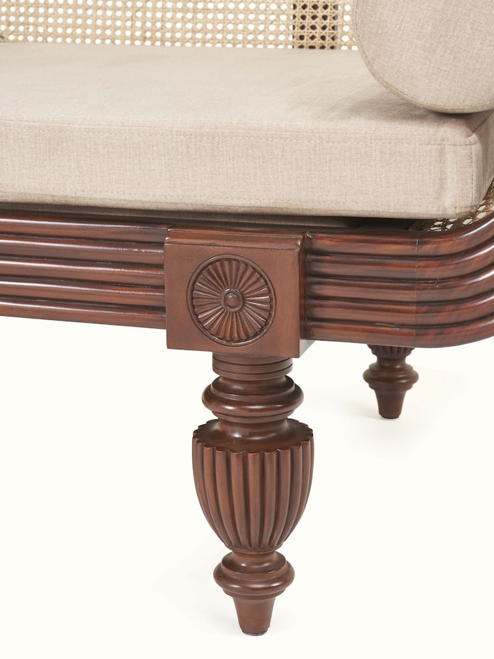 Close-up view of upholstered Mahogany wood and cane sofa showcasing refined cane craftsmanship and fabric texture