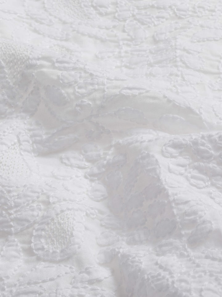 Close-up focusing on the fine craftsmanship and detailed hand embroidery stitches
