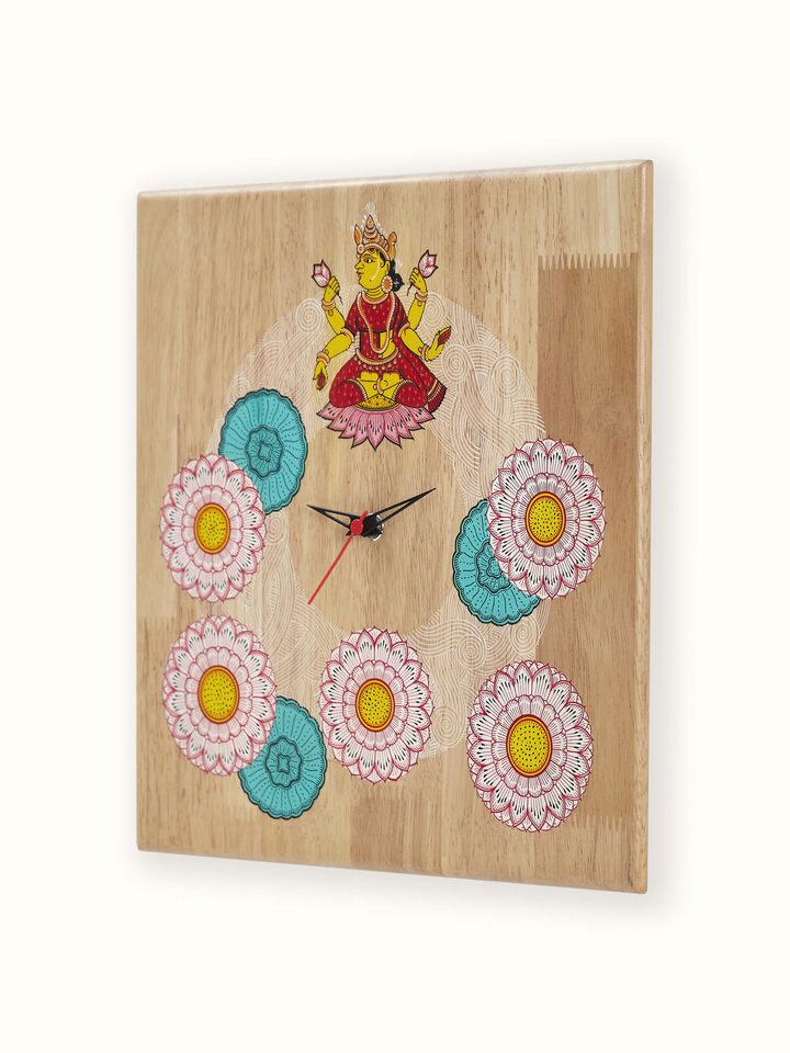 Angled view of painted Pattachitra Lakshmi wooden wall clock showing artwork