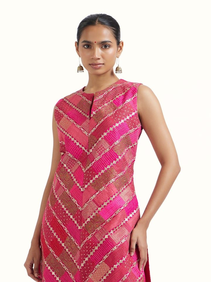 Angled view of pink silk hand embroidery kurta set highlighting craftsmanship and sheen
