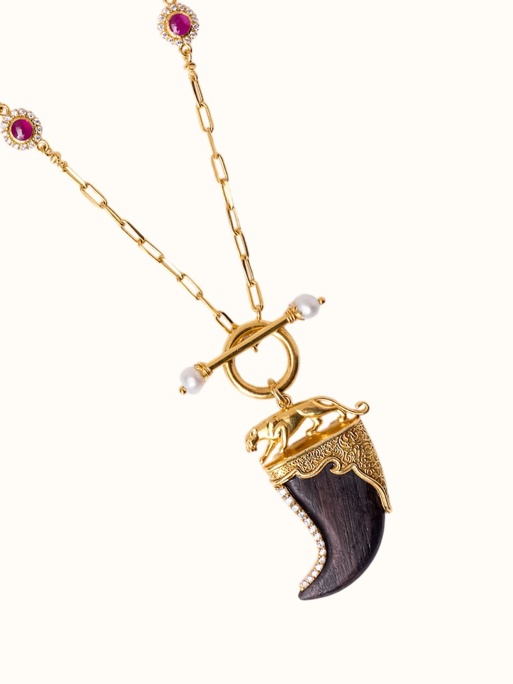 detail view of carved wood and silver pendant chain texture