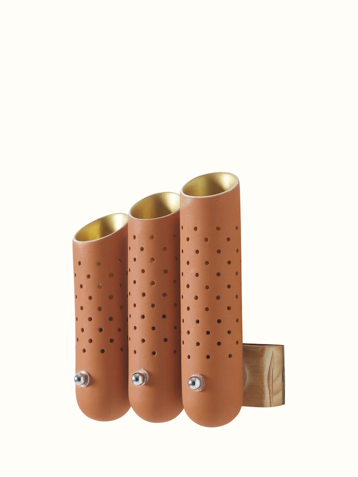 Angled view of natural terracotta wall light, focusing on the natural texture and design of the terracotta.