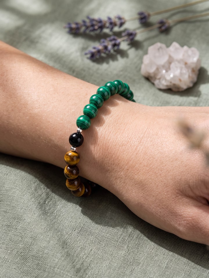 Styled view of Gemstone Tiger Eye, Black Onyx & Malachite Bead Silver Bracelet worn on the wrist, showing how it looks styled, from a different angle