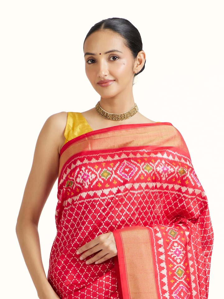 angled view of red weft ikat silk saree