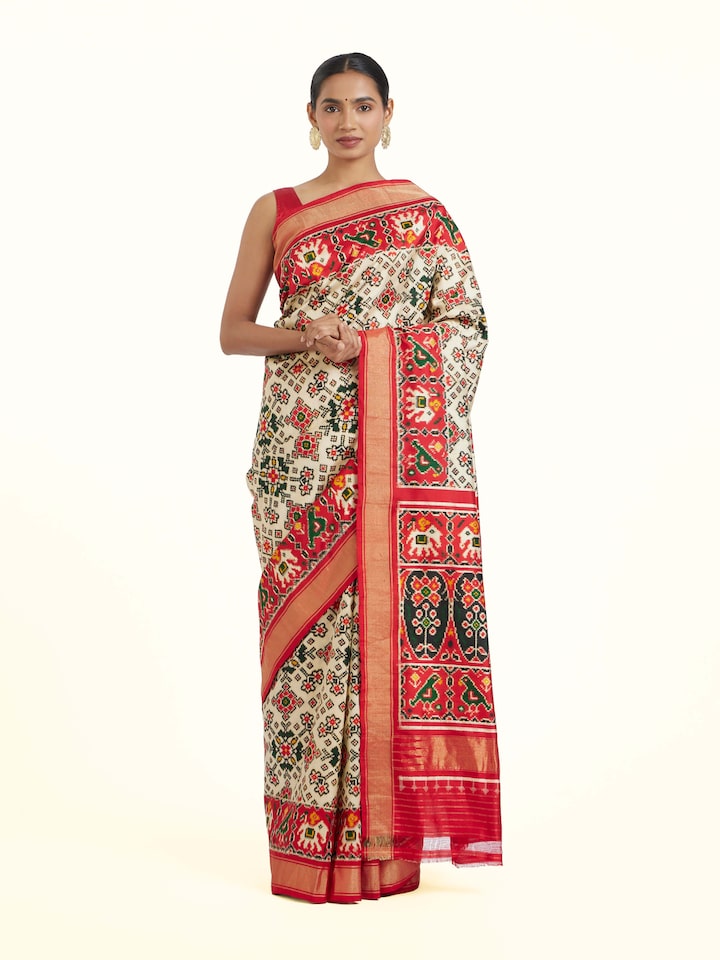 front view of cream pochampally double ikat silk saree with traditional pattern