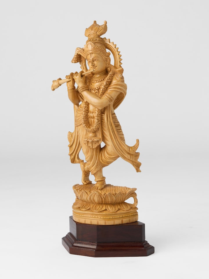 Angled view of the Wood Carved Krishna Flute Idol
