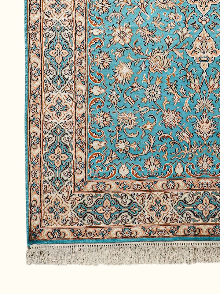 Close-up of the Traditional Persian Turquoise Medallion Kashmir Silk Hand-Knotted Carpet