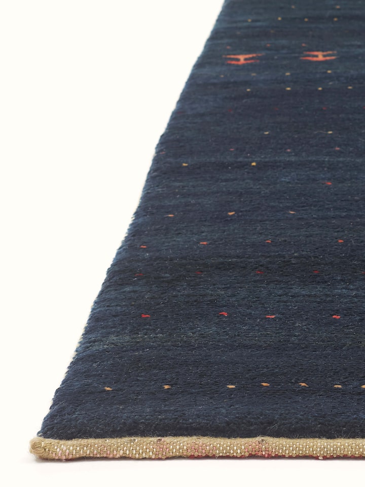 Angled view of the Traditional Gabbeh blue Jaipur wool hand-knotted carpet, emphasizing the design.