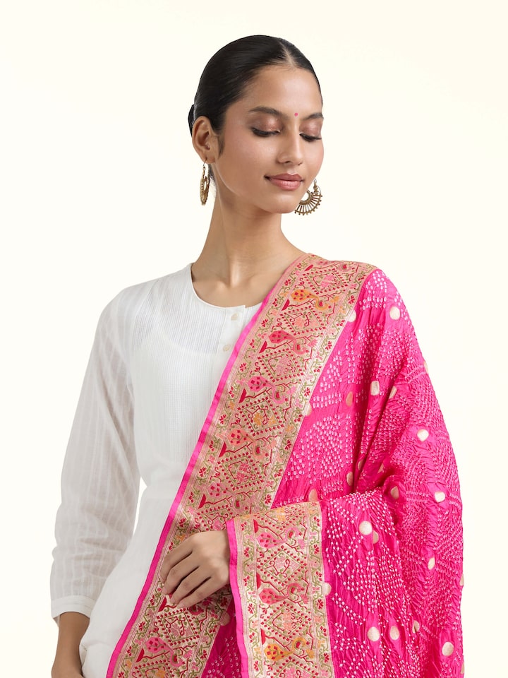Angled view of Dark Pink Bandhani Tie & Dye Silk Dupatta revealing the depth of its color and intricate pattern