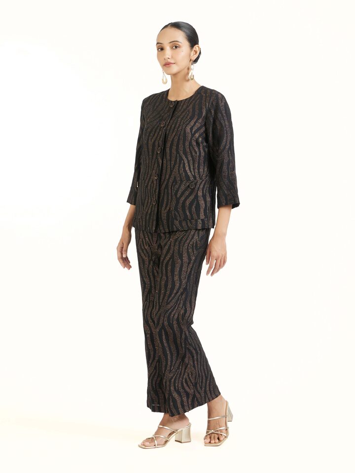 Side view of black Aari hand embroidered pants showcasing tailored fit