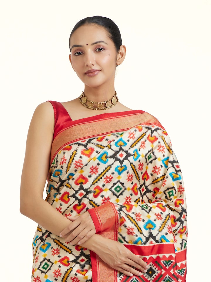 Angled view of Off-White Pochampally Double Ikat Saree revealing the depth of its color and intricate pattern