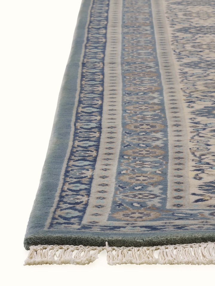 Angled view displaying intricate detailing and ornate border of Bhadohi wool Sarouk rug