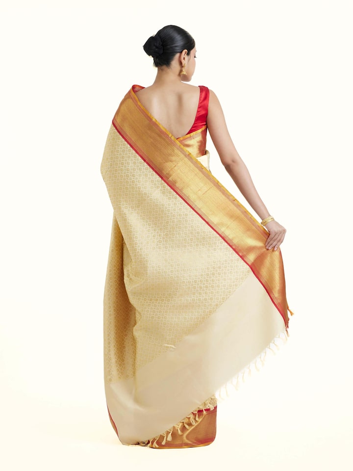 Back view of peach silk Kancheepuram saree displaying full pallu and overall elegance
