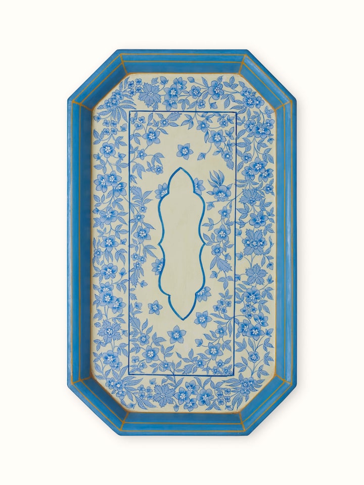 Close-up of multicolor papier-mache decorative tray with vibrant patterns.