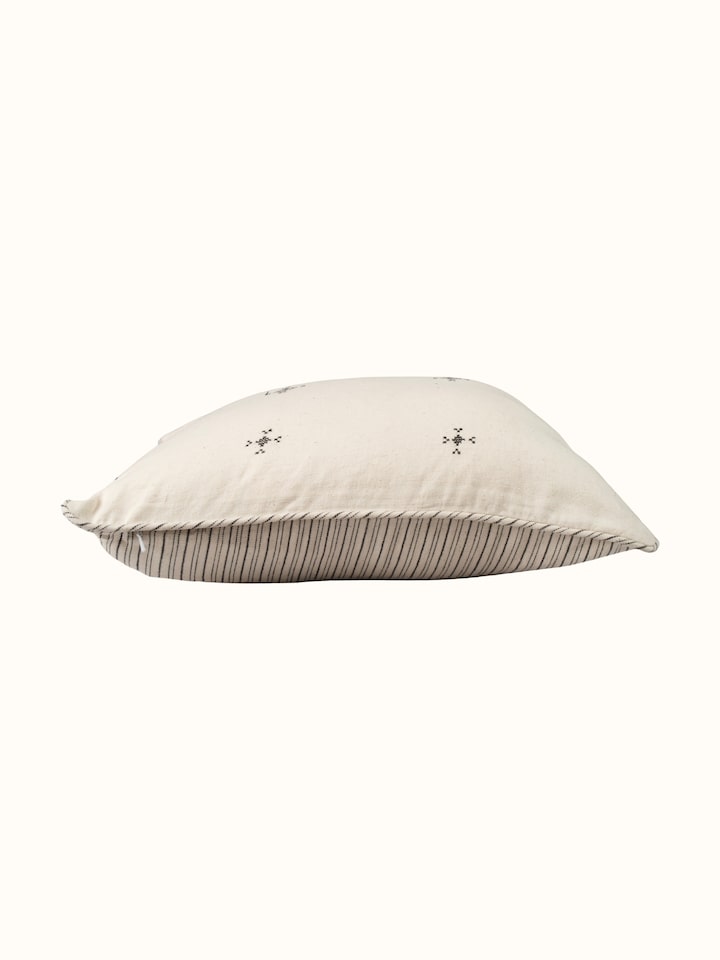 Folk geo hand embroidered buti cushion cover, angled view highlighting pattern
