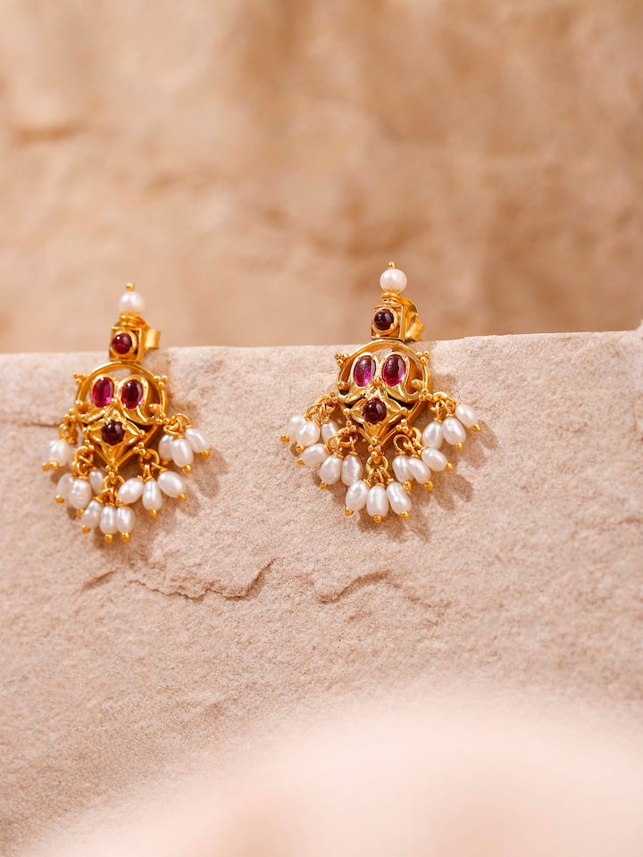 Styled detail view of Guttapusalu Silver Drop Earrings worn on the ear, shown in another styled shot
