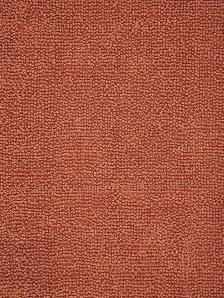 Close-up of cotton texture on Nityam rust bath mat