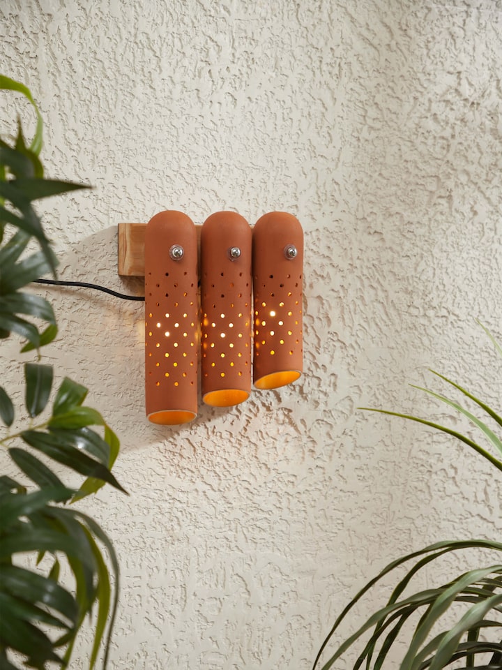Side view of natural terracotta wall light, showcasing the unique shape and handcrafted details.