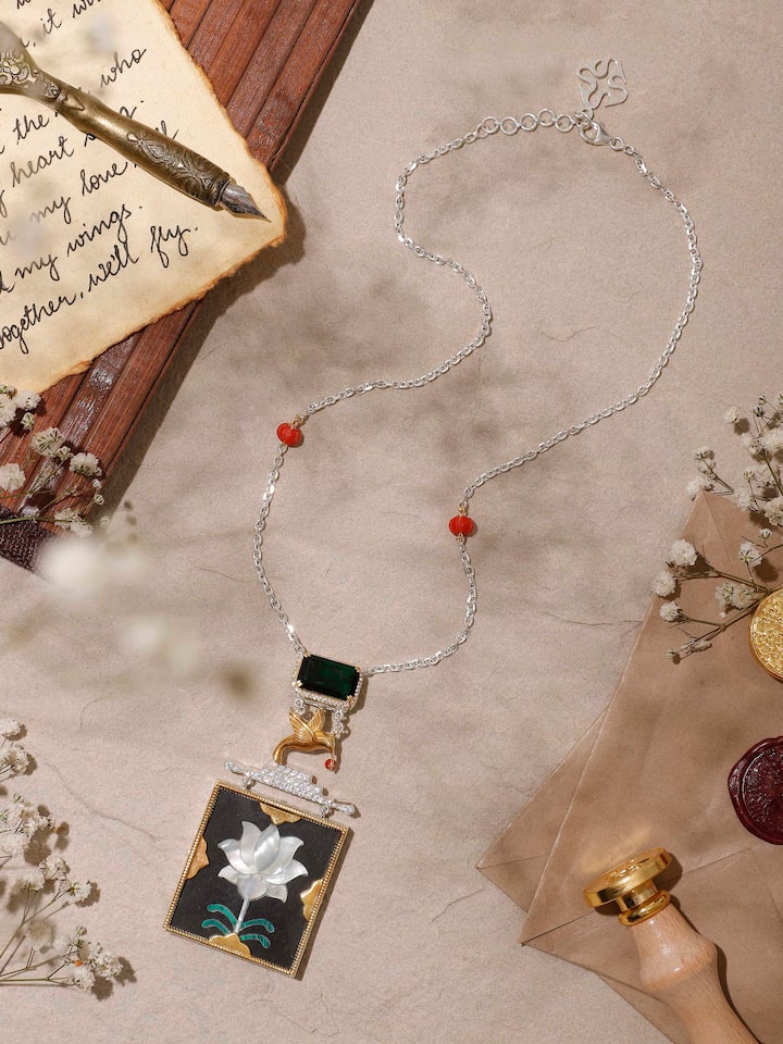 Side view highlighting the fine silver work and intricate design of the pendant