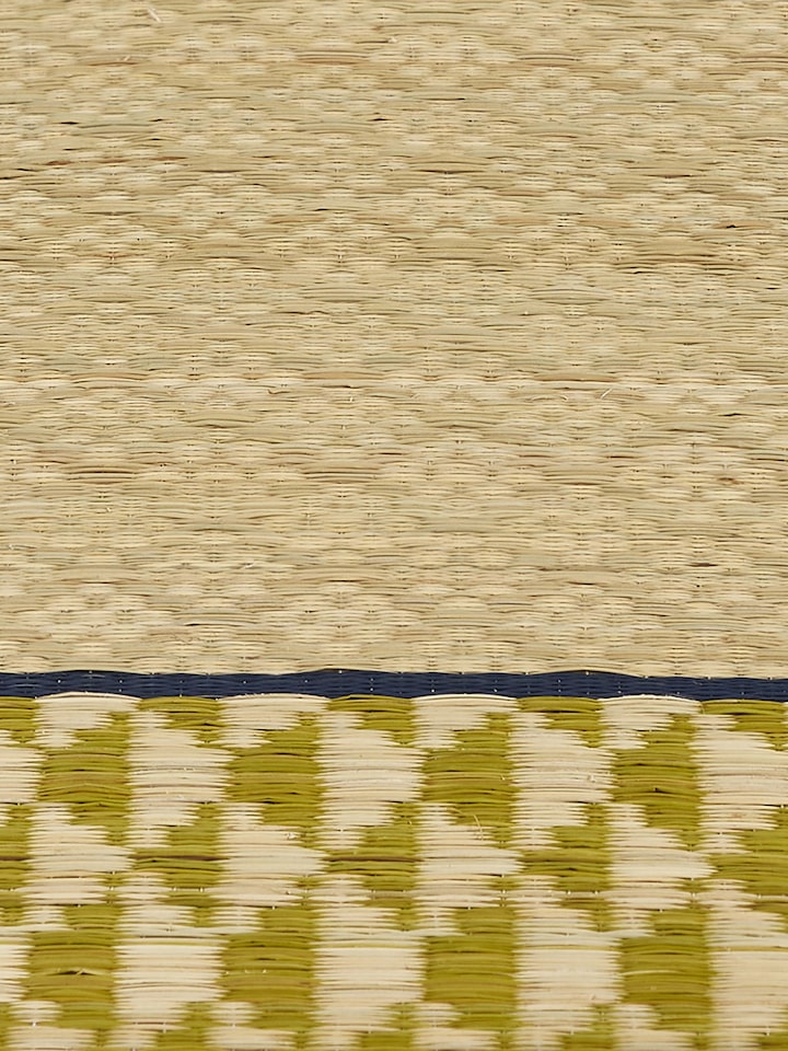 Texture and weave detail of Madurkathi green geo table mat
