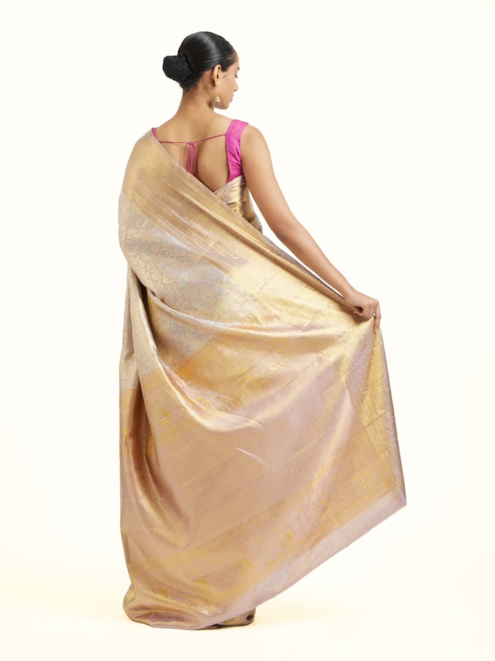 Back view of silver silk Kancheepuram saree displaying ornate pallu