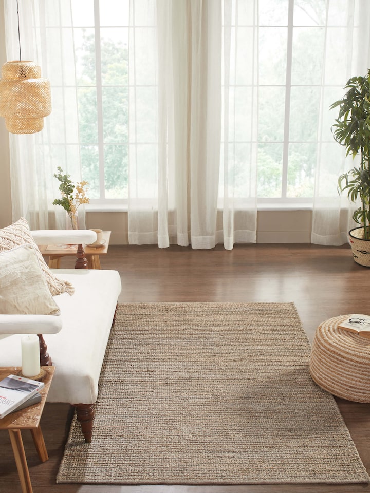 Lifestyle image featuring Solid Textured Grey Jute & Wool Rug placed in a modern living space