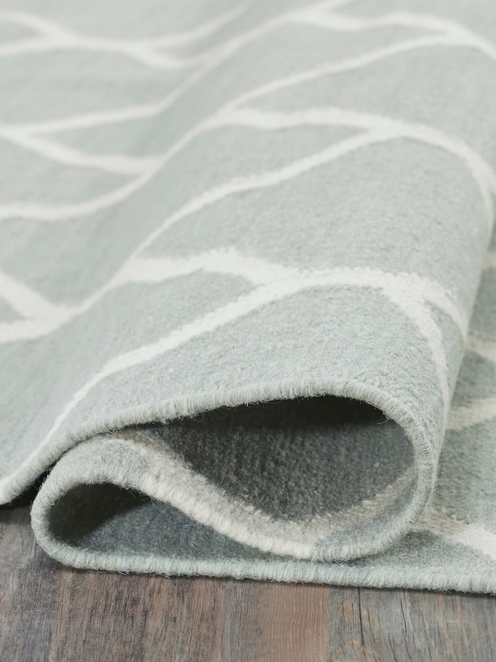 Side view emphasizing the dhurrie’s thickness and high-quality wool material