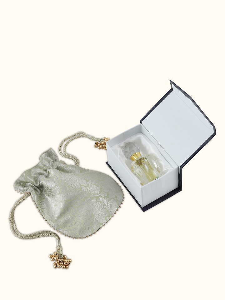 Overhead view of Attar Oudh Kashmiri perfume bottle with minimalistic golden cap and amber essence