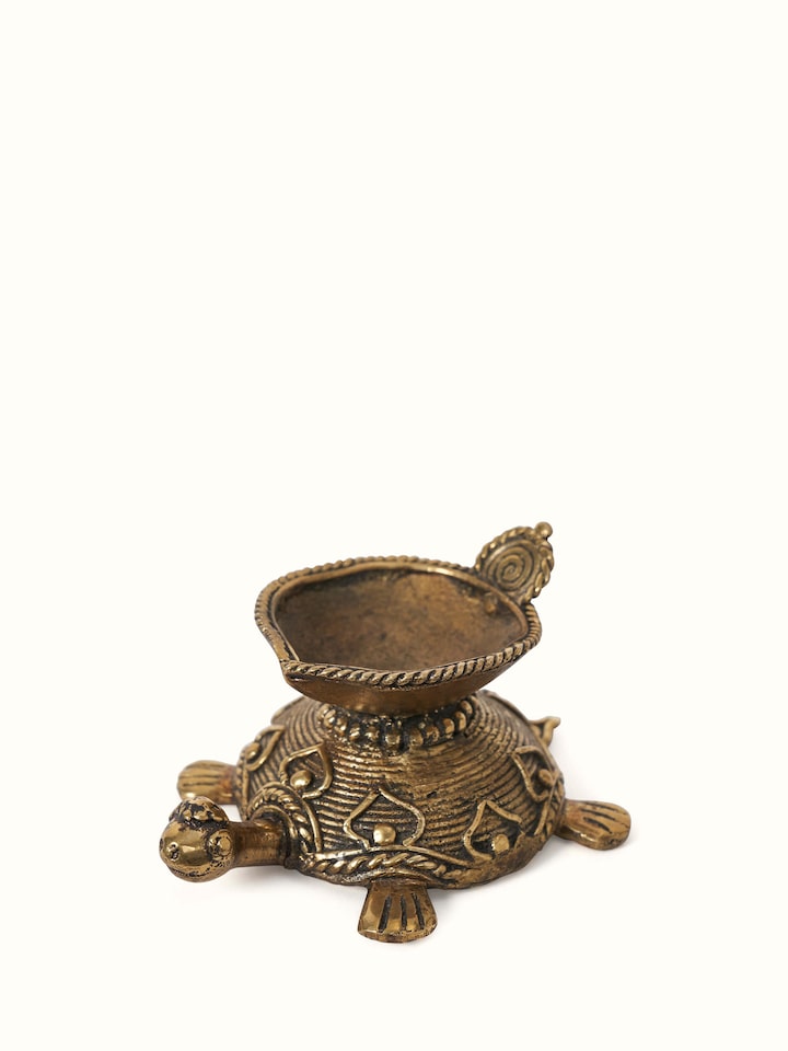 Angled view of Dhokra Brass Diya displaying its elegant shape and detailed brass design.
