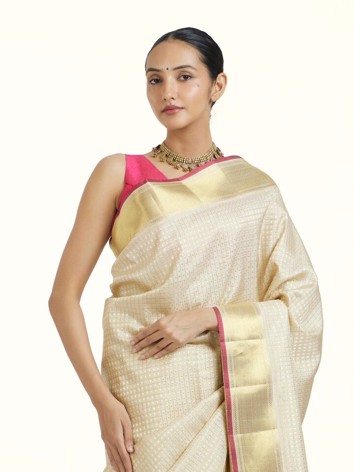Angled view of Beige Kancheepuram Silk Zari Saree revealing the depth of its color and intricate pattern
