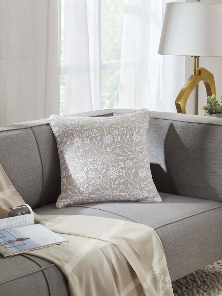 Styled view of Rann Beige Allover Linen Chikankari Hand Embroidered Cushion Cover styled on a table or bed setting