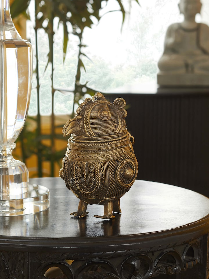 Dhokra art brass owl shape box showing side profile and carved textures