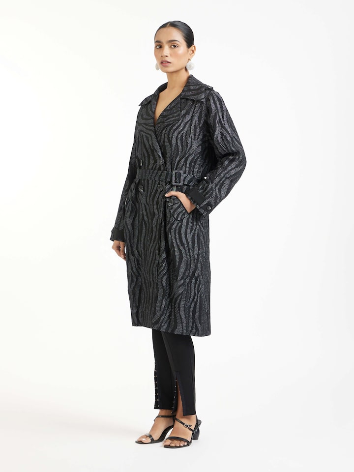 Side view of black aari hand embroidered trenchcoat highlighting tailored fit and detailing