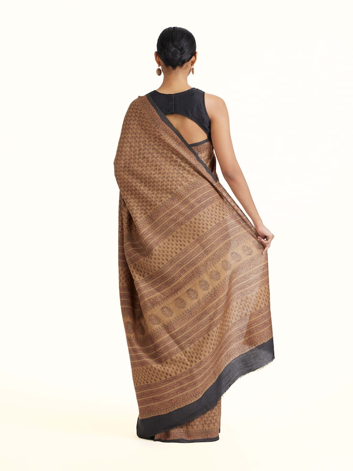 Back view of Beige Tussar Muga Silk Bagru Block Printed Saree emphasizing the overall design and fine details