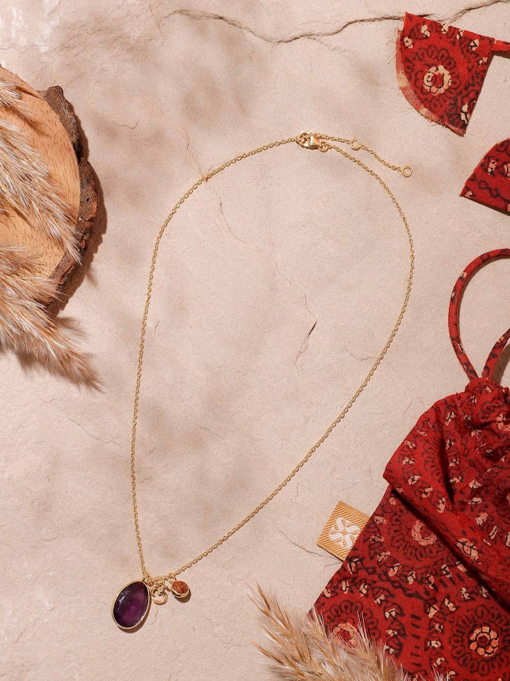 Styled detail view of Rudraksha, Om charm & Amythyst, 18K Gold Plated Silver Necklace shown in an alternate styled shot