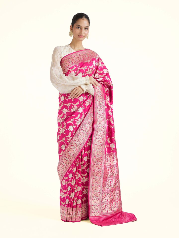 Front view of pink silk Banarasi saree with intricate zari woven motifs